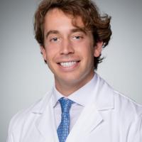Headshot of Alex Dash, MD